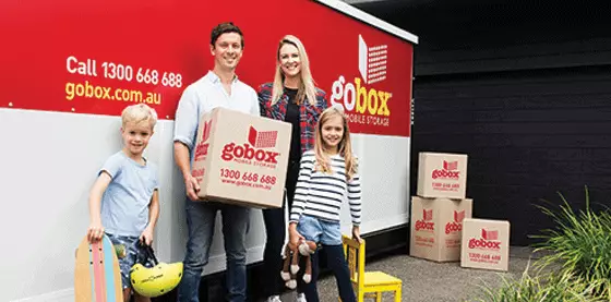 Family loading boxes into a goBox mobile storage container.